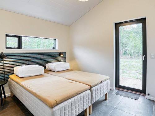 a bedroom with a bed with two pillows on it at 8 person holiday home in Læsø-By Traum in Læsø