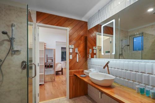a bathroom with a large sink and a shower at Countryside Calm Getaway with pool and deck in Auckland