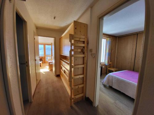 a bedroom with a bed and a book shelf in it at Appartement Tignes, 2 pièces, 6 personnes - FR-1-449-108 in Tignes
