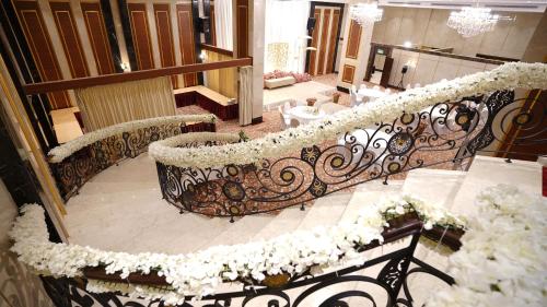 a staircase with white flowers on top of it at Rosemond Al Hamra in Jeddah