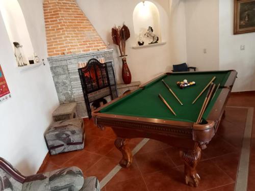 a room with a pool table and a fireplace at Hotel Boutique TEKALI INN in Cuetzalán del Progreso