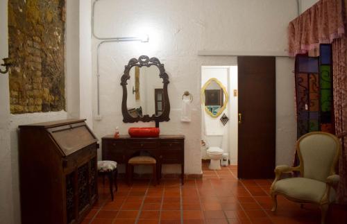 a bathroom with a vanity and a mirror and a toilet at Hotel Casa de la Luz in Bogotá