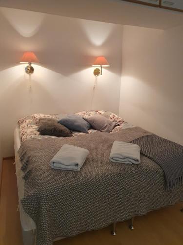 a bed in a room with two pillows on it at Apartment Marja's place in Rovaniemi