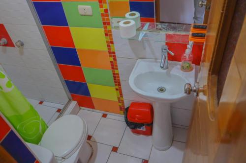 Baño colorido con lavabo y aseo en Inka City Hostel, en Cusco