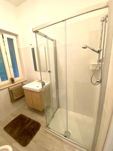 a shower stall in a bathroom with a sink at Villa Elisa in Minturno