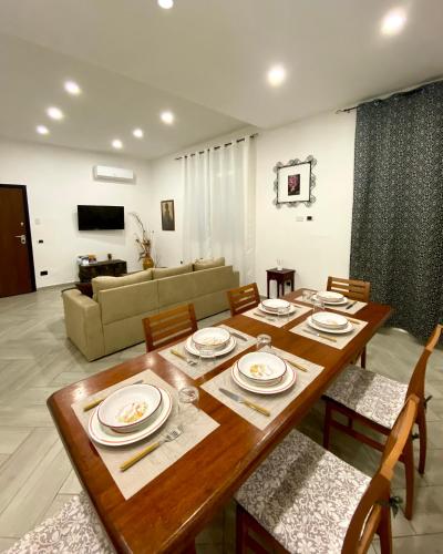 a living room with a wooden table and a couch at Villa Elisa in Minturno
