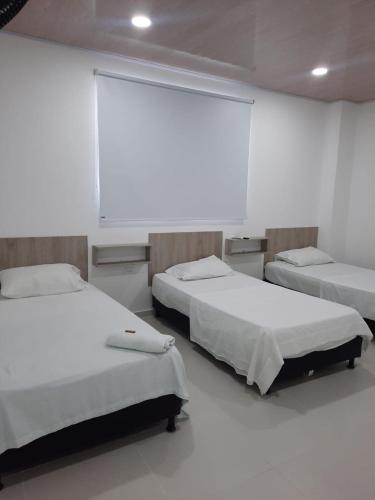 Postel nebo postele na pokoji v ubytování HOTEL MAR DEL CARIBE