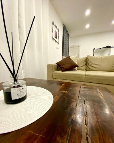 a living room with a couch and a vase on the floor at Villa Elisa in Minturno