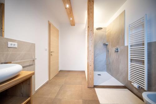 a bathroom with a shower and a sink at Apartments Stua da Carlo in Ortisei
