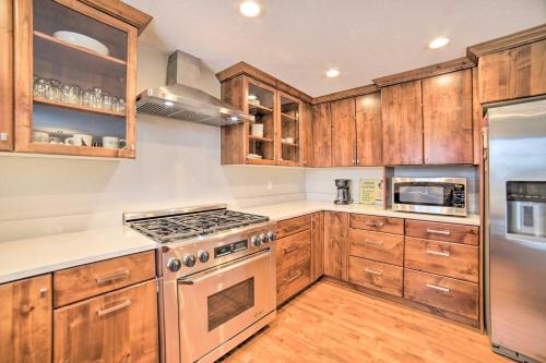 a kitchen with wooden cabinets and a stove top oven at Pocatello Retreat about 3 Mi to Downtown! in Pocatello