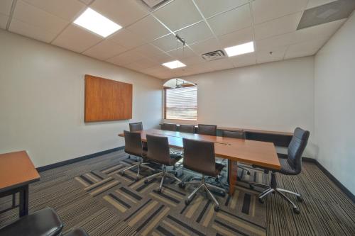 a conference room with a long table and chairs at Wingate by Wyndham and Williamson Conference Center in Round Rock