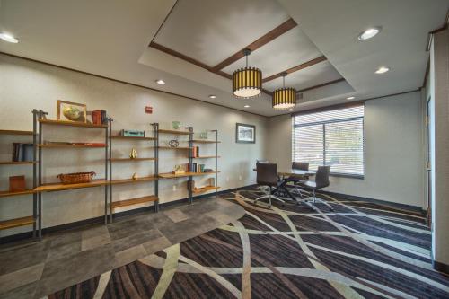 an office with a desk and a computer in a room at Wingate by Wyndham and Williamson Conference Center in Round Rock