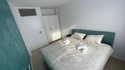 a bedroom with a bed with towels on it at Apartman Lux in Žepče