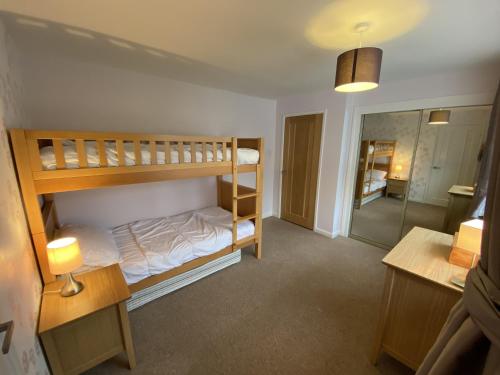 Zimmer mit 2 Etagenbetten und einem Bad in der Unterkunft BRAUNTON WHITE HOUSE 4 Bedrooms in Braunton