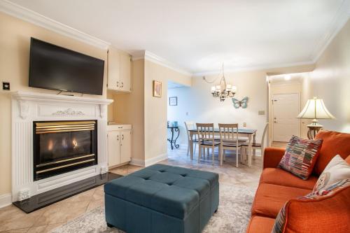 a living room with a couch and a fireplace at Dolly Dreams Fireplace Minutes to Dollywood in Pigeon Forge