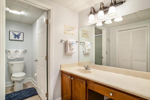 a bathroom with a sink and a toilet and a mirror at Dolly Dreams Fireplace Minutes to Dollywood in Pigeon Forge
