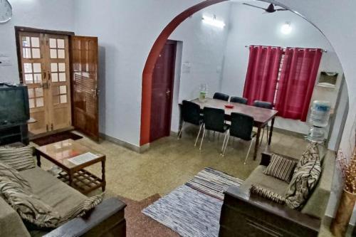 a living room with a couch and a table with chairs at 3 bedroom country home with a lush full backyard in Trichūr