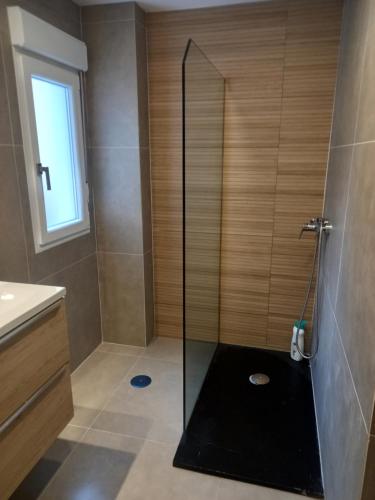 a shower with a glass door in a bathroom at POWER HOME in Granada