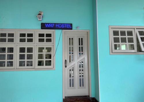 a house with two windows and a white door at WR7 Hostel in São Bernardo do Campo