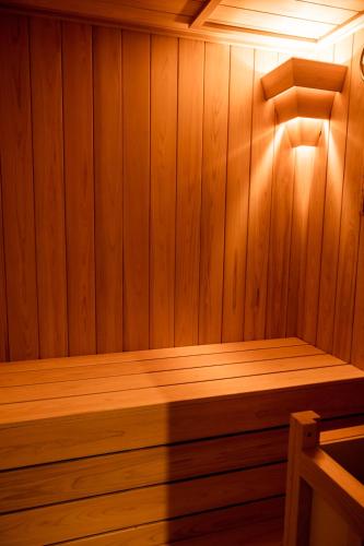 a wooden sauna with a wooden bench in it at Hakone Onsen Ryokan Yaeikan in Hakone