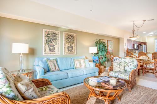 a living room with a blue couch and chairs at Waikoloa Fairway Villas #L22 in Waikoloa