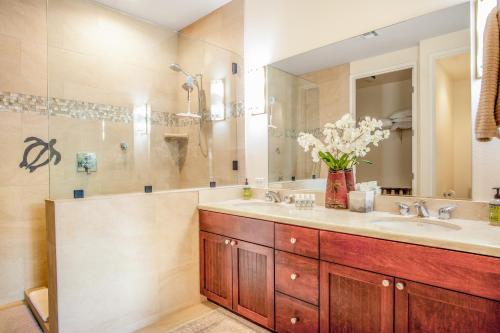 a bathroom with two sinks and a mirror at Waikoloa Fairway Villas #L22 in Waikoloa