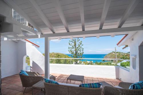 a patio with chairs and a view of the ocean at Windjammer Landing Resort and Residences in Gros Islet