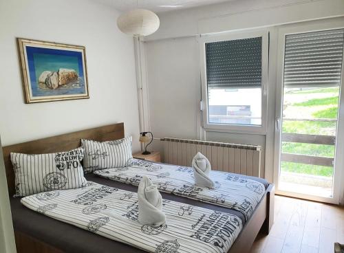 a bedroom with two beds and a window at At the heart of Plitvice Lakes - Self check-in! in Plitvička Jezera