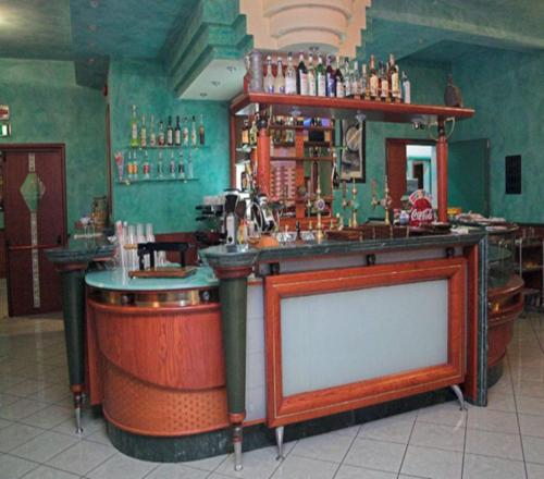 a bar in a pub with a counter with aperature at Hotel Apan in Reggio di Calabria