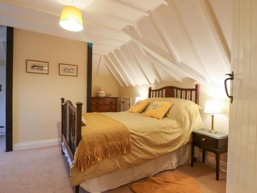 a bedroom with a bed and a white ceiling at Posbury Lodge in Crediton
