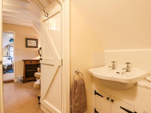 a white bathroom with a sink and a sink at Posbury Lodge in Crediton