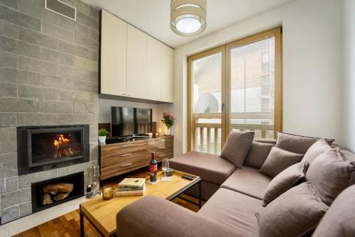 a living room with a couch and a fireplace at Secluded Mountain Cozy Studio with Fireplace in Bansko