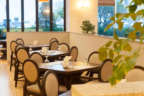 a row of tables and chairs in a restaurant at Fontana Beach Hotel in Mokpo