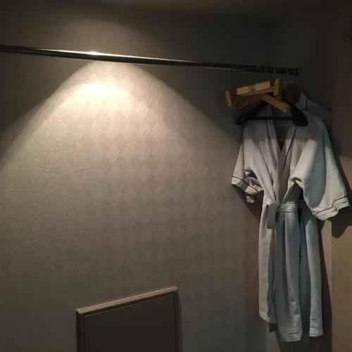a robe hanging on a rack in a bathroom at 레전드호텔 in Daejeon