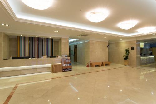 a lobby with a waiting area in a building at Fontana Beach Hotel in Mokpo