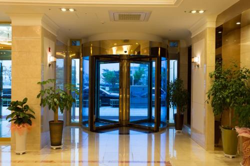 a lobby with a revolving door in a building at Fontana Beach Hotel in Mokpo