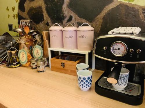a counter with a coffee maker and cups on it at Kuća za odmor Bajka in Jastrebarsko