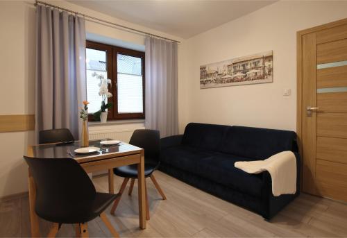 a living room with a couch and a table at Willa na Plażowej in Węgierska Górka