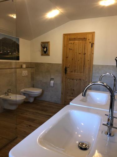 a bathroom with a sink and a toilet at Red Deer Resort in Bad Wiessee