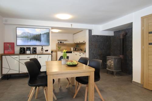 a kitchen and dining room with a table and chairs at Willa na Plażowej in Węgierska Górka