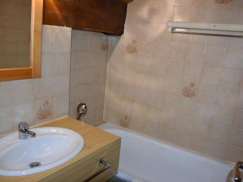 een badkamer met een wastafel en een ligbad bij Chaleureux Appartement 3 Pièces à 400m du Téléphérique - FR-1-464-150 in Pralognan-la-Vanoise
