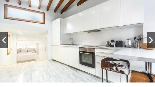 a kitchen with white cabinets and a counter top at Hotel-Apartment Modern Studio in Palma de Mallorca
