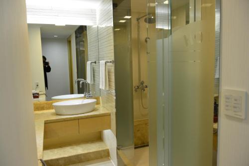 a bathroom with a sink and a shower at Fontana Beach Hotel in Mokpo