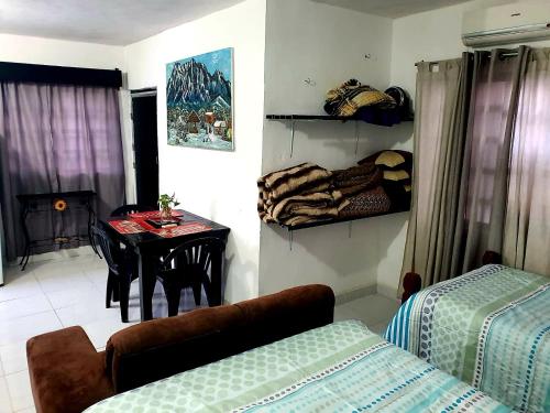 a room with a bed and a table with a chair at Casa "Hielo" Potrero Chico in Hidalgo