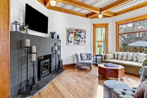 a living room with a fireplace and a tv at Bespoke Inn Flagstaff in Flagstaff