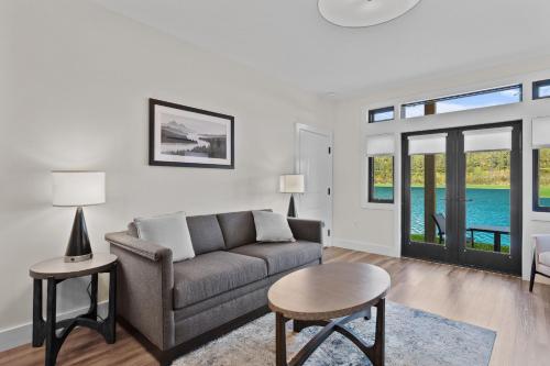 a living room with a couch and a table at Owl's Nest Resort in Thornton