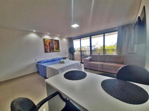 a living room with a bed and a couch at GoldFlat in João Pessoa
