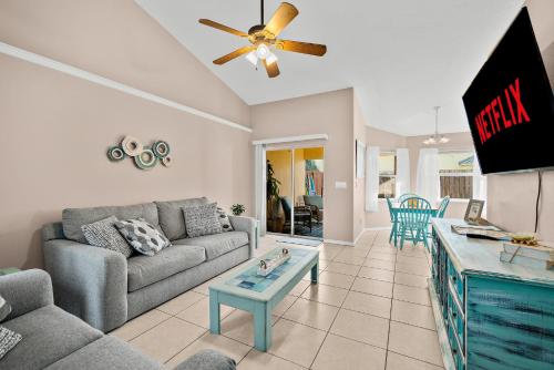 a living room with a couch and a table at Sunset Serenity - 3BR Beach Townhome with outdoor patio - NEW HOT TUB, Steps to Ocean Fun! in Melbourne