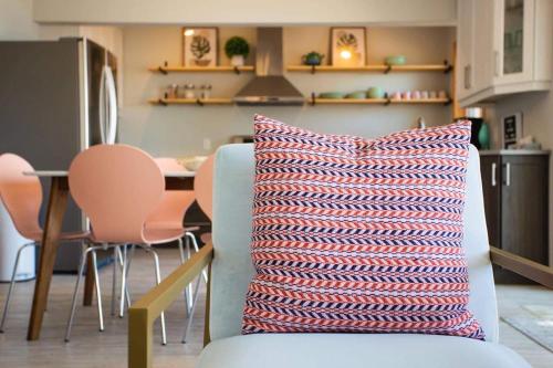 a blue couch with a striped pillow in a kitchen at The Finch Beach Resort in North Bay