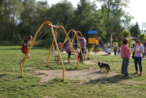a group of people playing in a park with a dog at Willa na Plażowej in Węgierska Górka